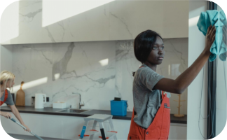 a woman cleaning on the kitchen